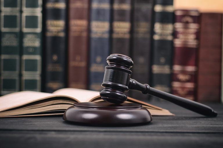 Law and Justice , Legality concept, Judge Gavel and law book on a black wooden background, law library concept.