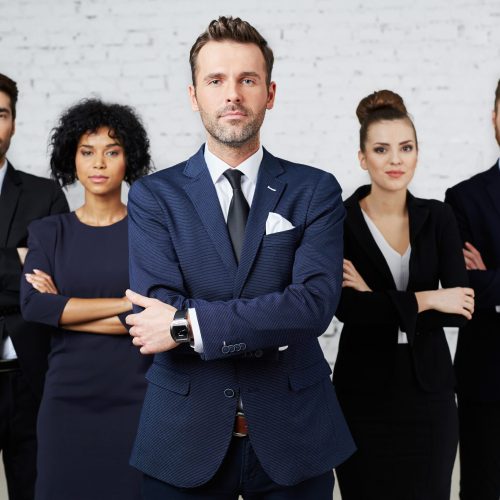 Group of perky lawyers, businesspeople standing together